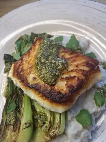 Seared fish with pesto over risotto